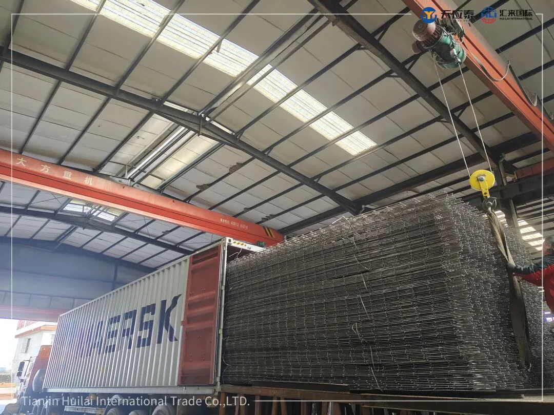 Bundled steel wire mesh being loaded into a shipping container